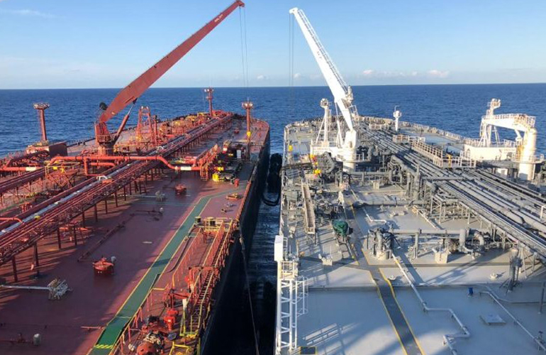 oil survey inspection during bulk cargo loading operations at commercial port terminal.