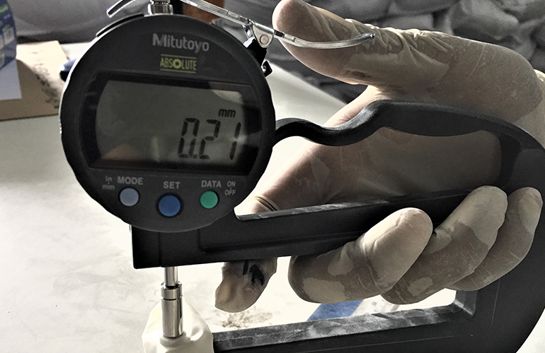 Cargo surveyor using measuring device to inspect cargo condition