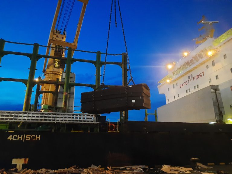 P&I Malaysia coverage for port operations and cargo handling at commercial shipping terminal during sunset.