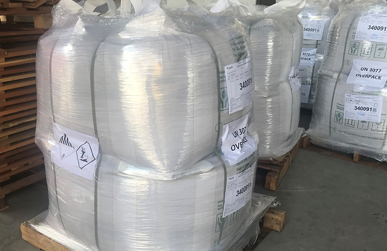 Large industrial bulk bags secured for safe transit as container cargo.