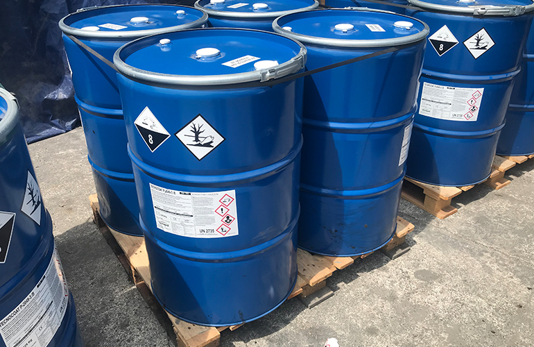 Liquid chemical blue drums staged and ready for container cargo stuffing.