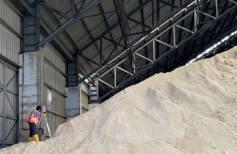 Monitoring and mapping a high-volume stockpile inside a storage facility.